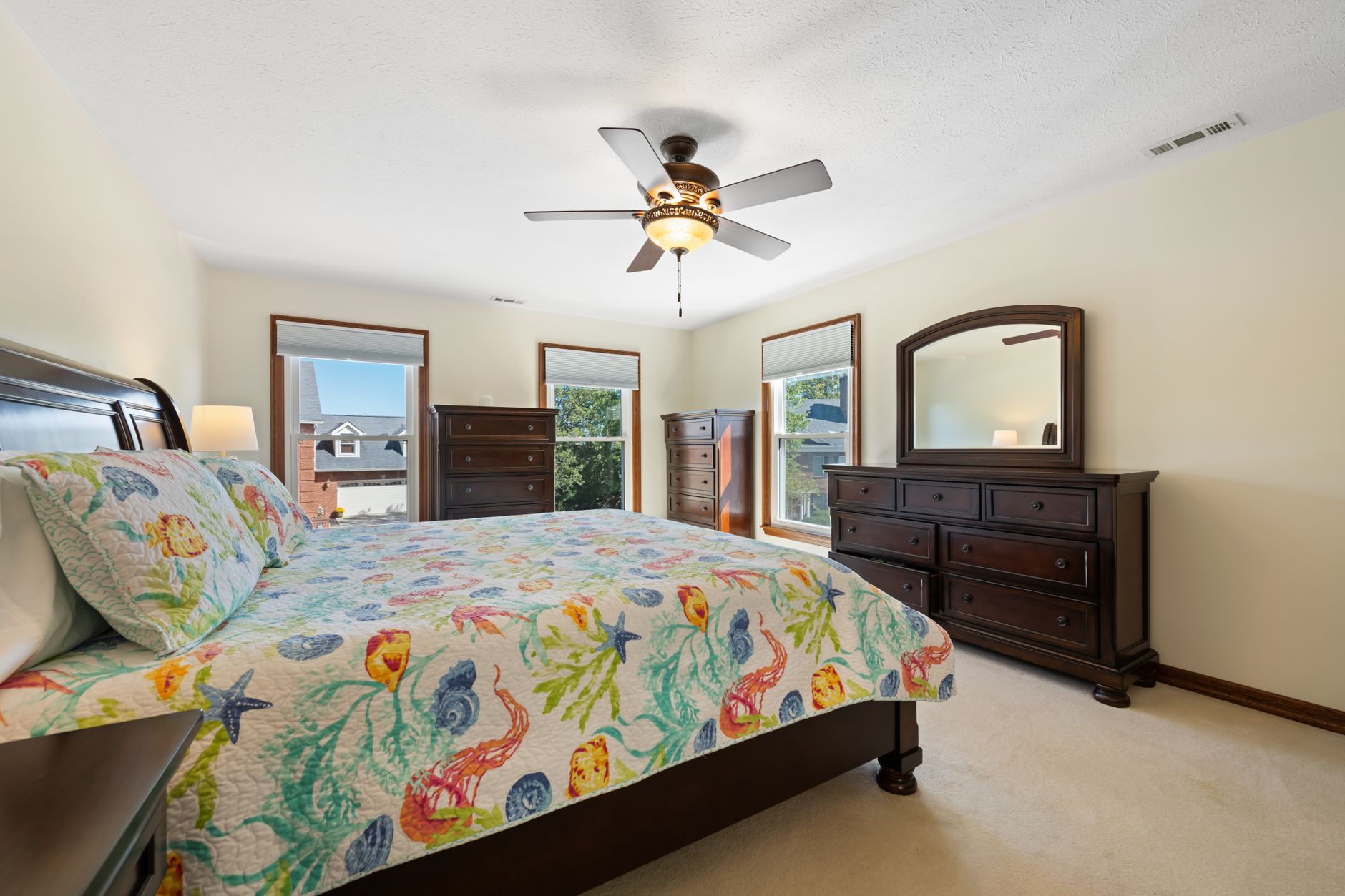 Bright bedroom with white linen and wooden furniture
